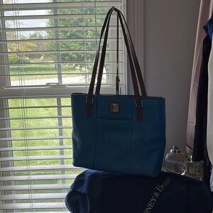 Blue Dooney & Bourke ladies bag with red lining. Good condition